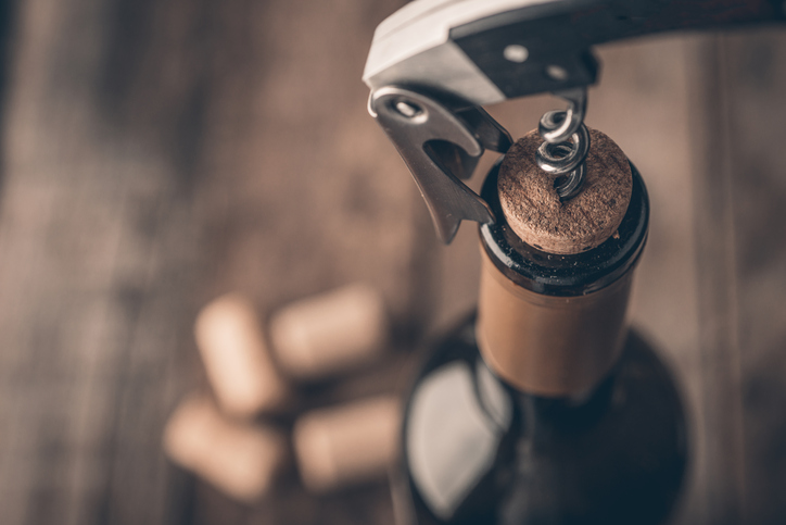 Corkscrew and bottle of wine